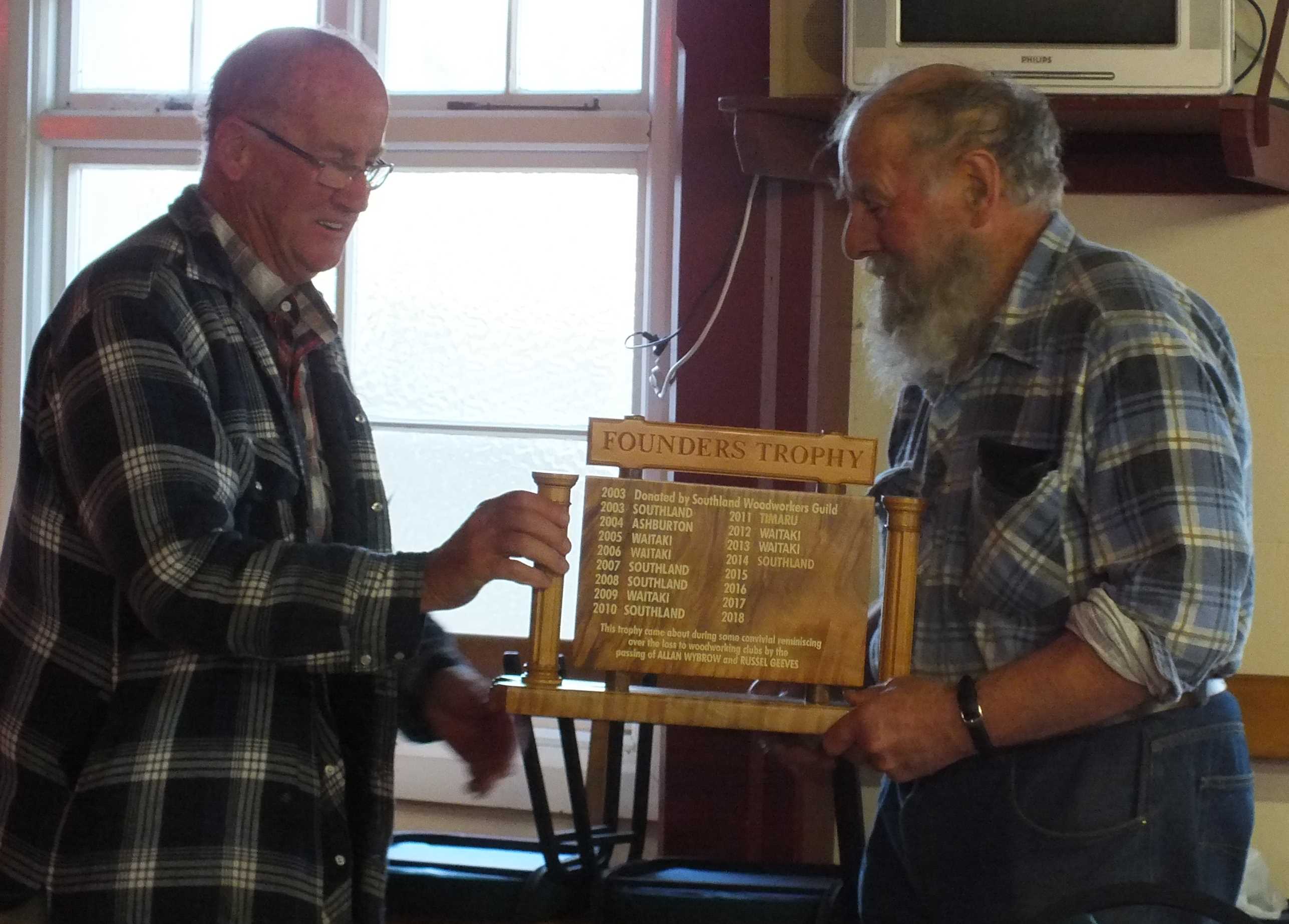 Rex accepts the Founders Trophy on behalf of the club